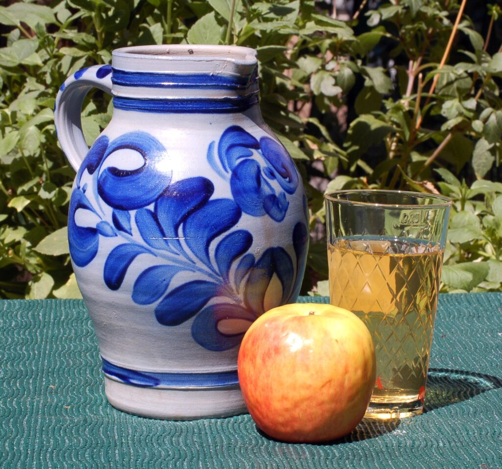 Frankfurt apple wine served in a ribbed glass with a blue Bembel jug