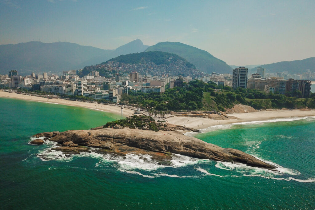 Aerial view of Arpoador rock and beach with mountains in Rio de Janeiro