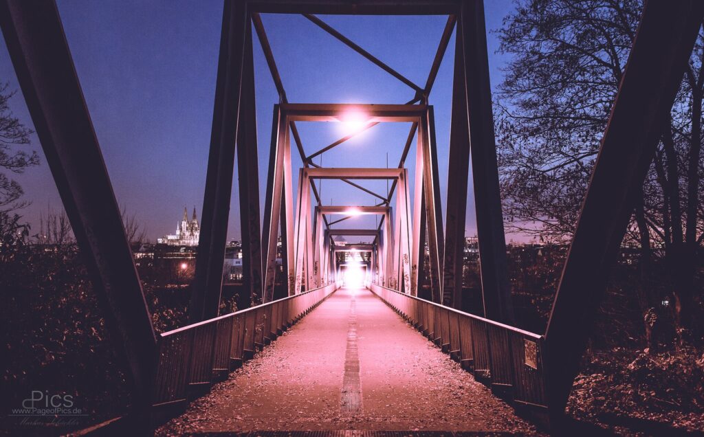 The walkway of the Hohenzollern Bridge in Cologne at dusk