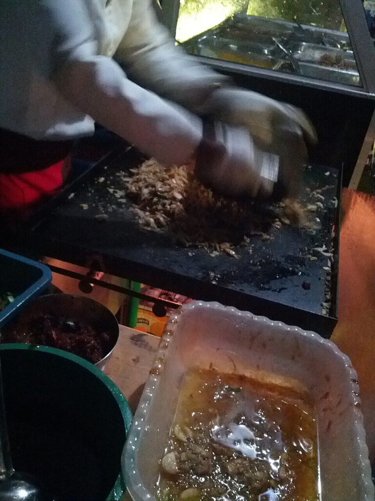 Kottu being made at a street stall, Sri Lanka