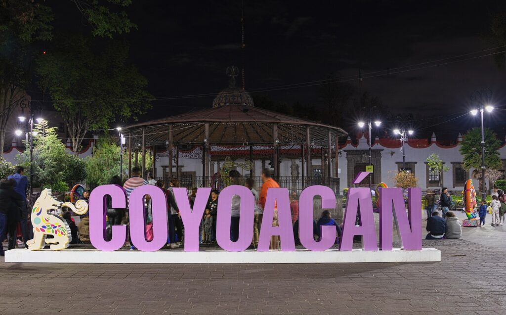 Colourful Coyoacan letters sign lit up at night in Mexico City