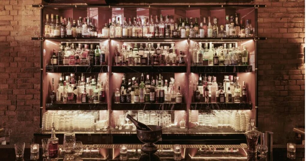 Bottle-lined back bar at Experimental Cocktail Club in Paris