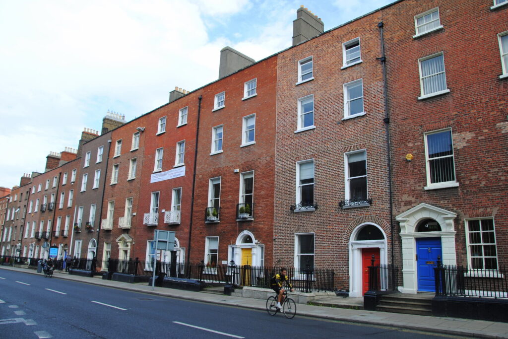 Colorful Georgian doors along a red-brick street in Dublin