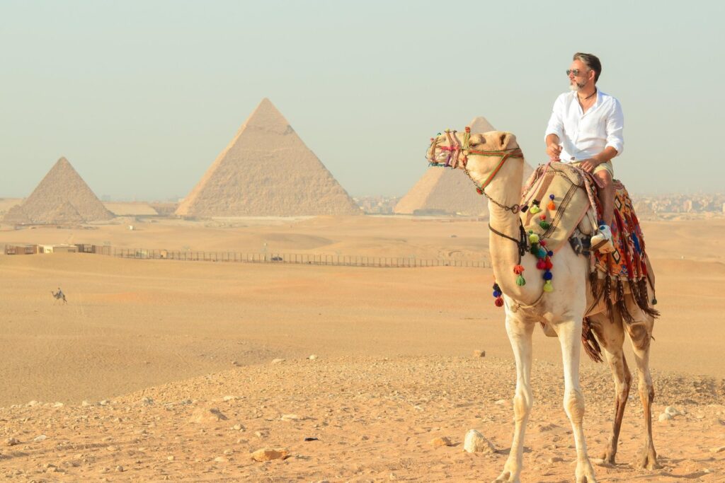 Camel ride at sunrise by the Giza pyramids near Cairo