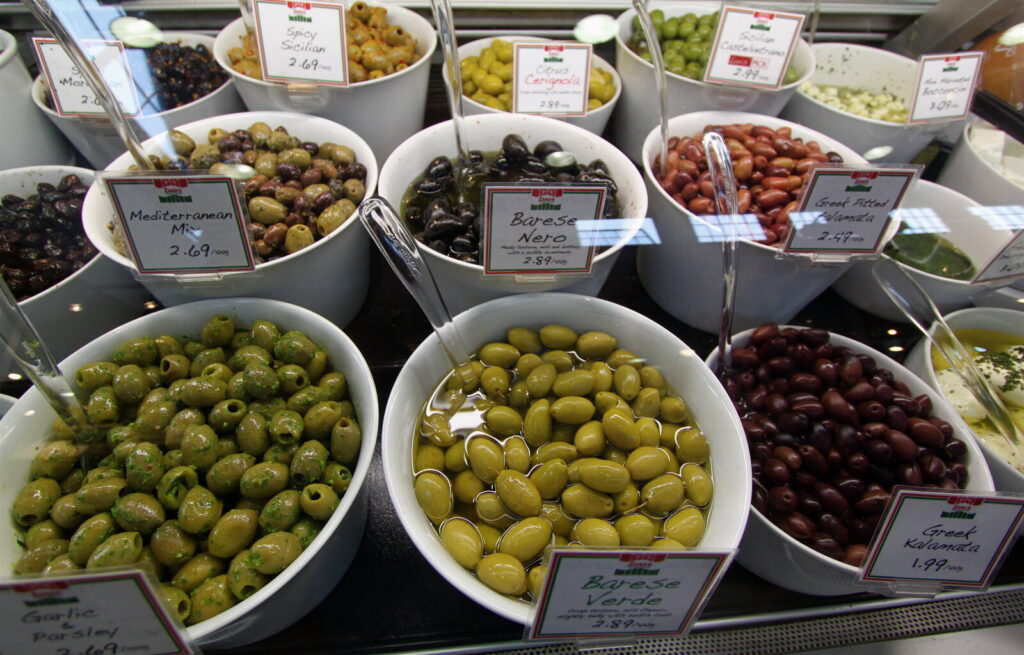 Colorful produce and olive stalls inside Granville Island Public Market in Vancouver