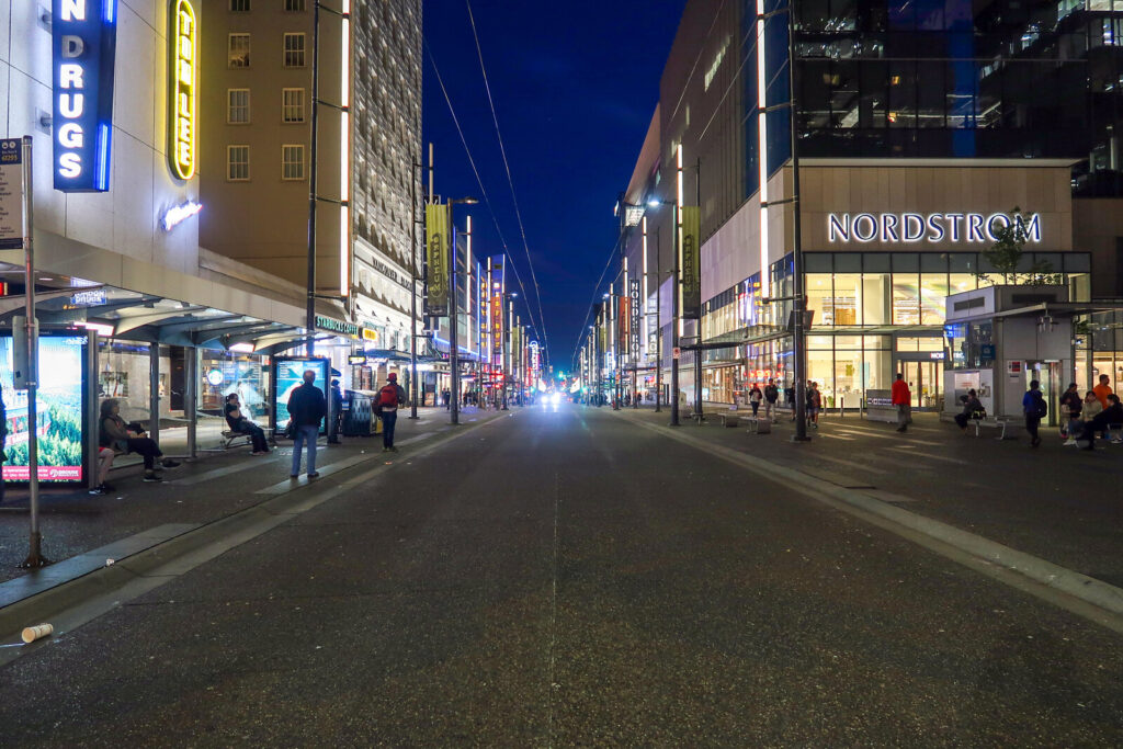 Granville Street nightlife with neon signs at dusk in downtown Vancouver