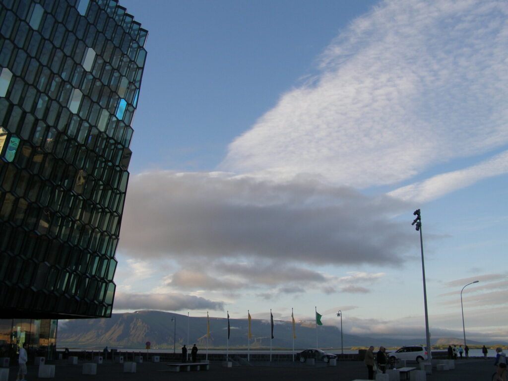 Harpa Concert Halls glass honeycomb facade against a blue sky in Reykjavik
