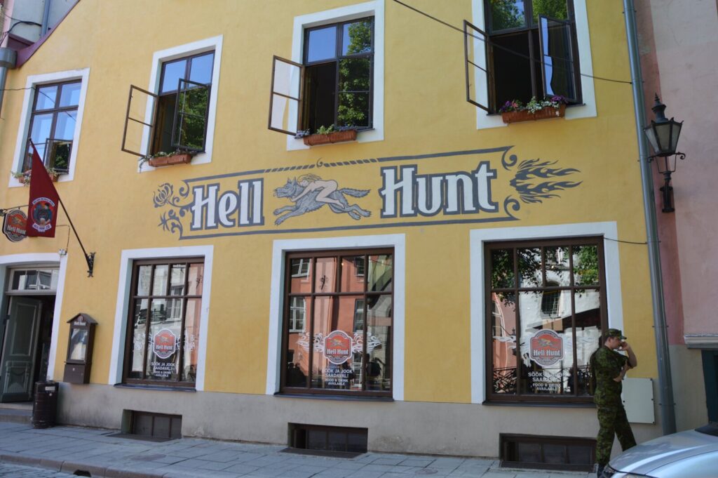 Yellow facade of Hell Hunt pub with its sign in Tallinn old town