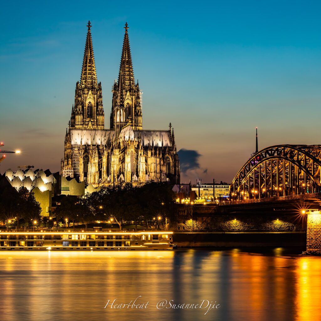 The Hohenzollern Bridge and Cologne Cathedral at dusk
