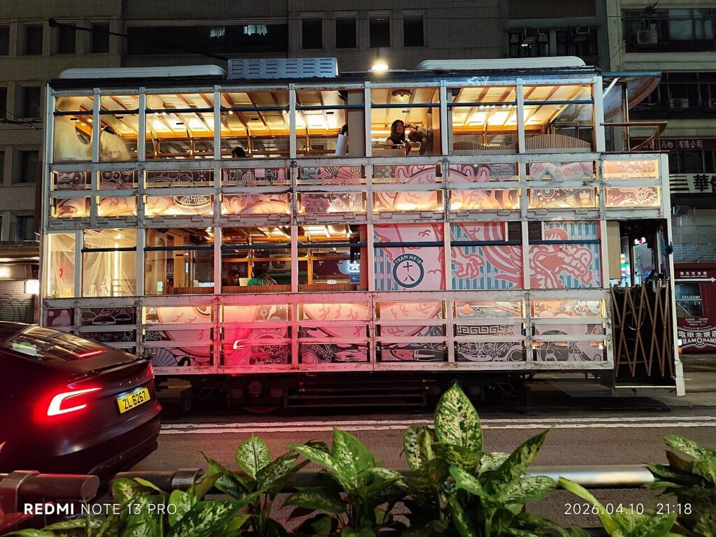 Illuminated double-decker tram at night in Central, Hong Kong