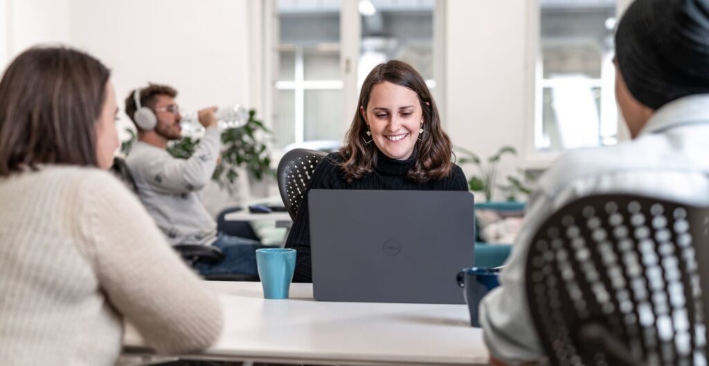 Bright coworking space with people at laptops at Impact Hub in Budapest