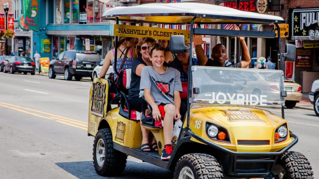 Joyride sightseeing cart with riders on Broadway in downtown Nashville