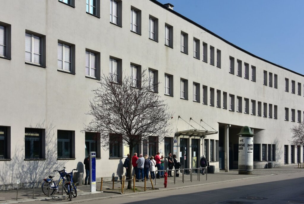 Oskar Schindler's Factory museum facade with visitors in Kraków