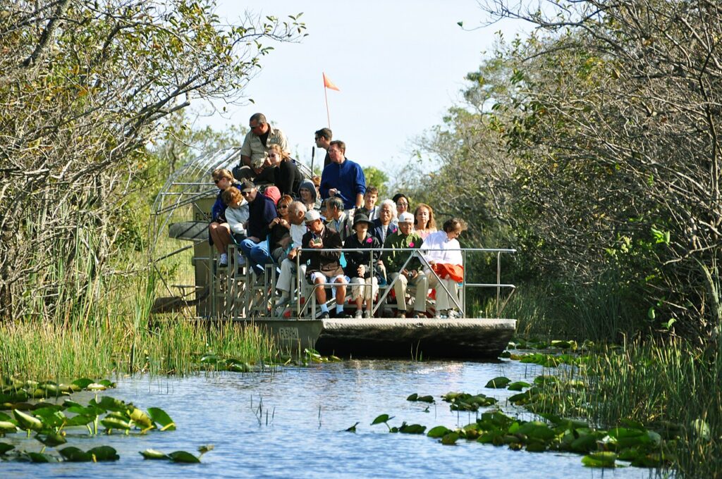Tourist airboat gliding across the Everglades sawgrass