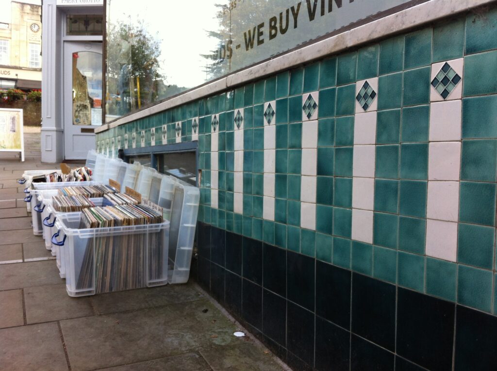 Crates of vinyl records at an independent record store like Sweat Records