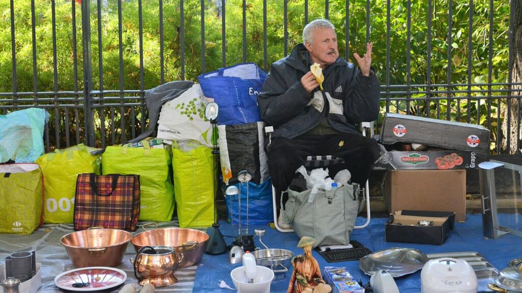 Vendor with copperware at the Place des Fetes market in Paris