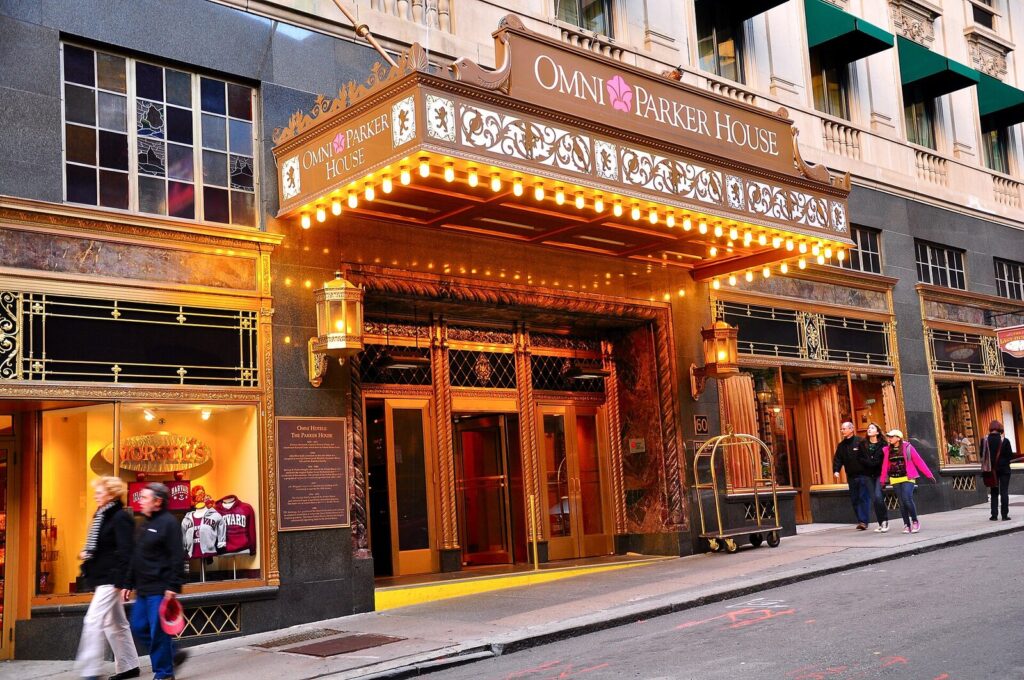 Historic Omni Parker House hotel entrance lit warmly at dusk in downtown Boston