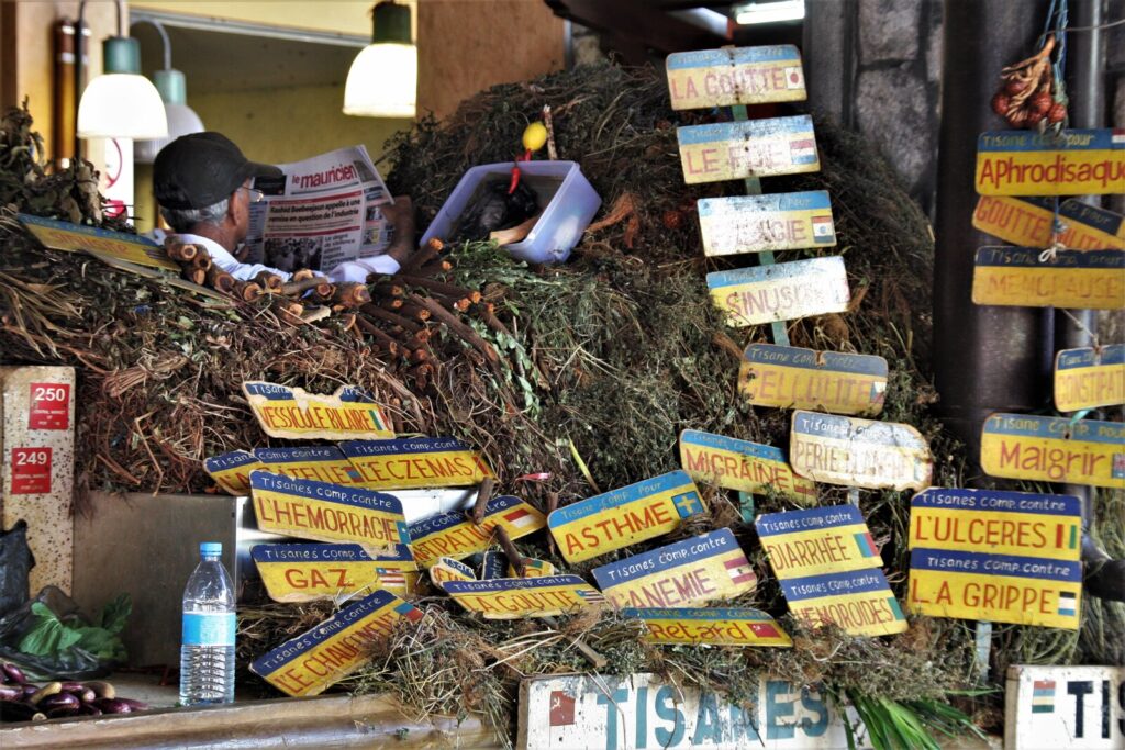 Colorful herbal tisane remedy stall at Port Louis Central Market in Mauritius