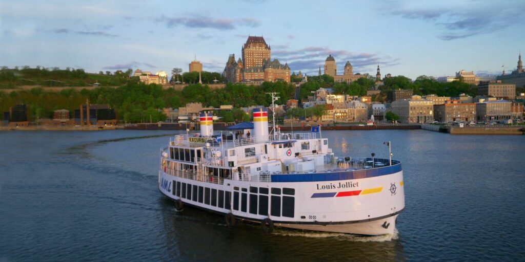 Sightseeing cruise boat on the St Lawrence River by Old Quebec