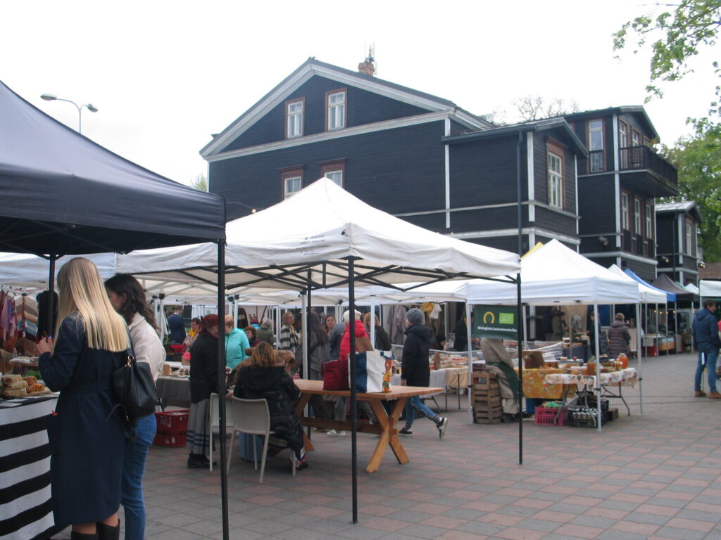Kalnciema Quarter Saturday market with craft and food stalls and shoppers in Riga