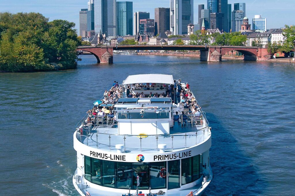 Sightseeing boat on the river Main with the Frankfurt skyline