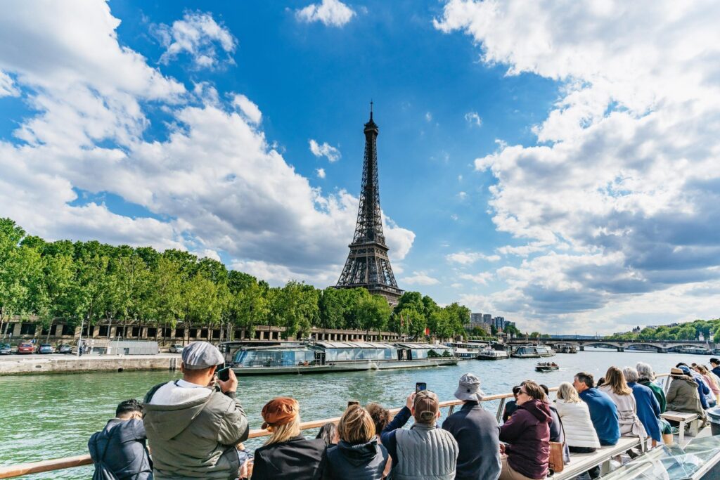 Sightseeing boat cruising the Seine past the Eiffel Tower in Paris