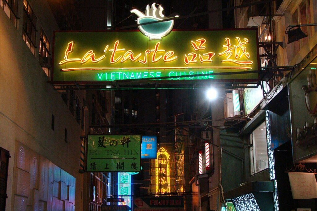 Glowing neon signs on Stanley Street at night in Central, Hong Kong