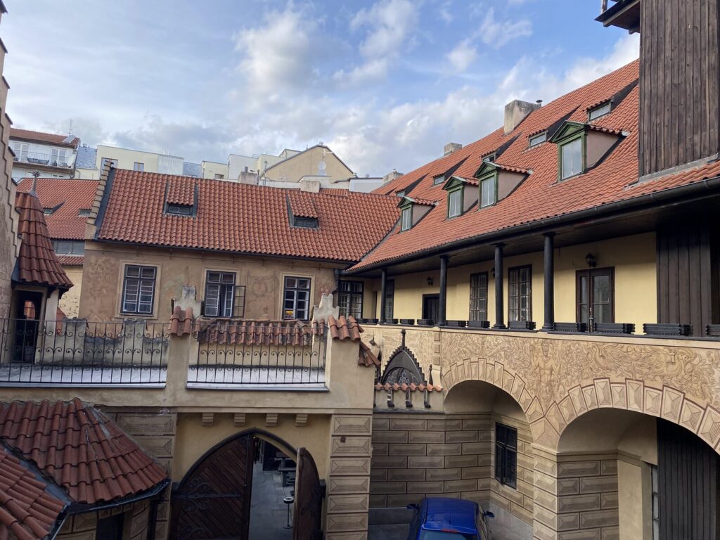 Historic U Fleku brewery courtyard with red-tiled roofs in Prague
