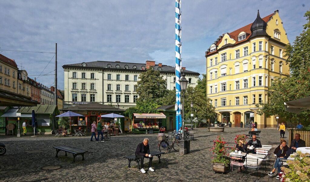 Wiener Platz market square with Bavarian maypole and stalls in Munich