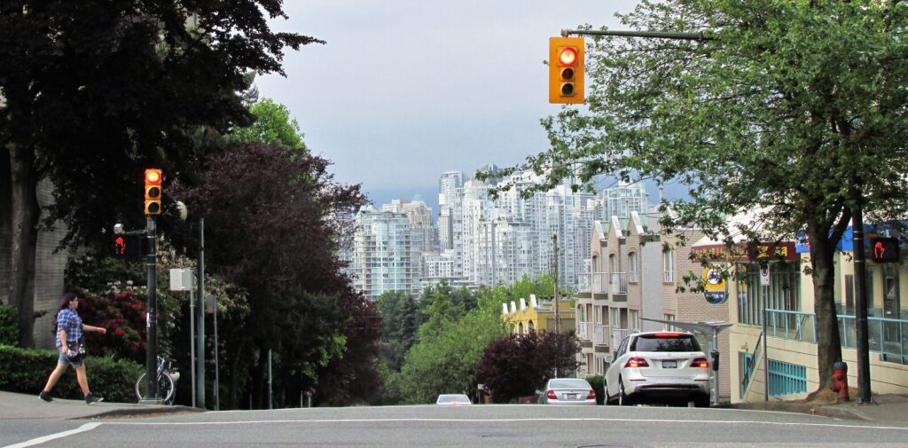 Leafy Yaletown shopping street with high-rise skyline in Vancouver